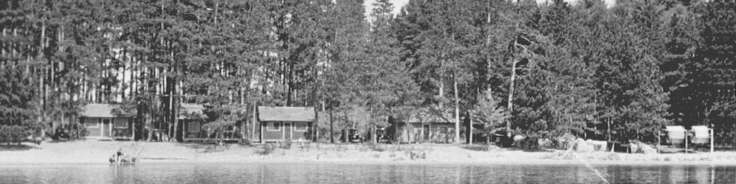 Trout Lake Station black and white photo of cabins along lakeshore