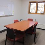 Small conference room offers quiet place for 5 to work with a monitor and video/audio connections